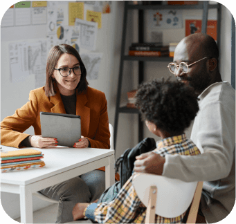 Teacher having meeting with parent of schoolboy