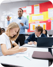 Classroom with diverse students and a teacher. Students, teacher, and classroom environment, learning and collaboration. Education setting with engaged students. Teacher teaching high school class.