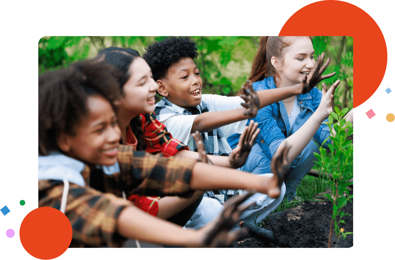 Diverse teenage boy and girls playing with mud