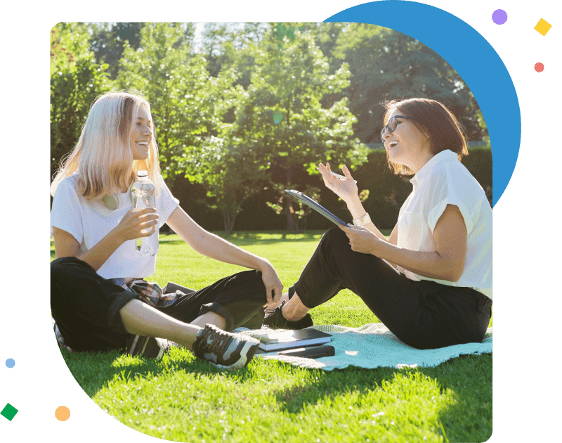 teacher and teen student talking in a yard